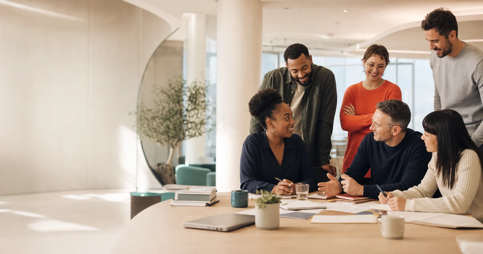 Colleagues discussing a plan around a table